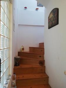 a staircase in a home with wooden floors and white walls at private house next to the sea in Pefkochori