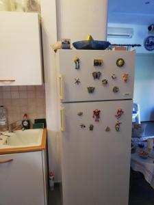 a refrigerator with magnets on it in a kitchen at private house next to the sea in Pefkochori