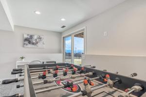 a gym with a lot of equipment in a room at NEW 5BR House with Peak Views in Colorado Springs in Colorado Springs