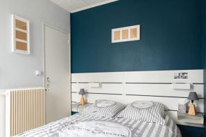 a bedroom with a blue accent wall and a bed at Sublime 30m In The Heart Of Paris in Paris