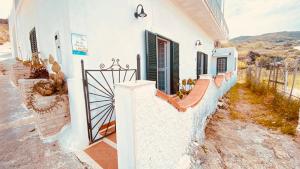 a house with white walls and a fence at Casa Ninetta - Immobilevante in Ponza