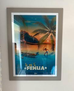 a framed picture of a man in the water with a palm tree at Grand Studio Les Horizons Papeete in Papeete