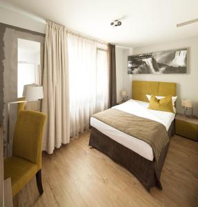 Säng eller sängar i ett rum på Art Hotel Aachen