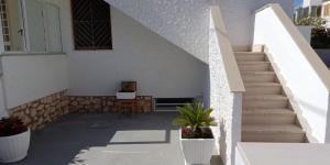 a staircase leading up to a white building with a plant at Casa Ser-Ale in Torre Canne