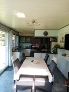 a kitchen with a white table and chairs in a room at Libenliny in Durbuy