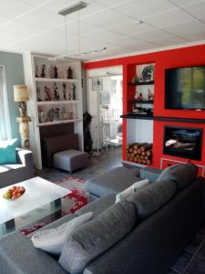a living room with a couch and a fireplace at Libenliny in Durbuy