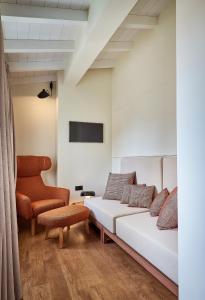 a bedroom with a bed and a chair at Regno Di Morea in Nafplio