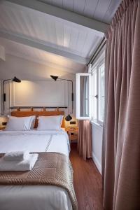 a bedroom with a large bed and a window at Regno Di Morea in Nafplio