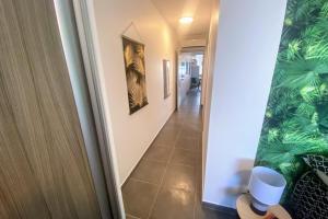 a hallway with a stairway leading to a room at Recent Bel Appartement une chambre Papeete in Papeete