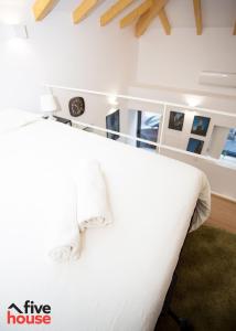 a bedroom with a large white bed with white pillows at FIVE HOUSE 16 in Porto