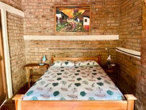 a bedroom with a bed in a brick wall at Jungle Cabins El Escondido in Muy Muy +25 photos