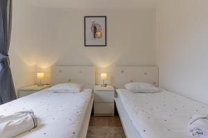 Posteľ alebo postele v izbe v ubytovaní Apartmani Utmar Cres