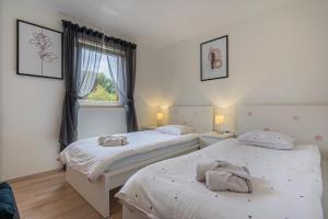 Posteľ alebo postele v izbe v ubytovaní Apartmani Utmar Cres