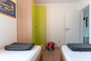 Posteľ alebo postele v izbe v ubytovaní Apartmani Utmar Cres