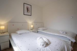 Posteľ alebo postele v izbe v ubytovaní Apartmani Utmar Cres