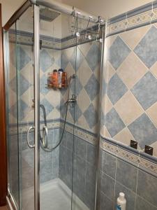 um chuveiro com uma porta de vidro na casa de banho em Casa Antares em Stintino