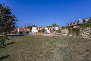 a view of a yard with houses in the background at Vilar do Jardim - Terrace and Pool - Vilamoura in Quarteira