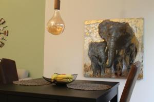 a dining room table with a painting of an elephant at Appartement Delfi in Flensburg