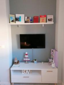 a white entertainment center with a tv on a wall at Casa IRIENSE VUT-CO-004308 in Padrón