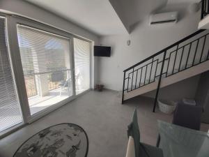 a living room with a staircase and a large window at Apartment Olea in Marina