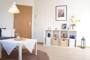 a living room with a white table and a couch at Pirk in Norden