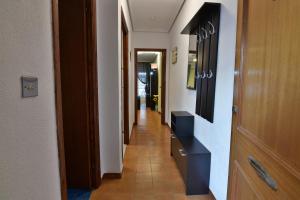a hallway with many doors and a hallway with a hallwayngth at Apartamento Gregorio in Torrevieja