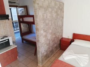 a small bedroom with a bunk bed and a kitchen at Villa Christina Sea Side in Hanioti