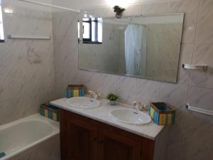 a bathroom with two sinks and a tub and a mirror at Vivenda Bemposta in Alvor +39 photos