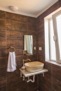 a bathroom with a large sink and a mirror at Vila Troia Vama Veche in Vama Veche