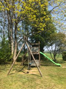 an old swing set in a field with trees at Les Caliciades 1 à Gros-Fays in Gros-Fays