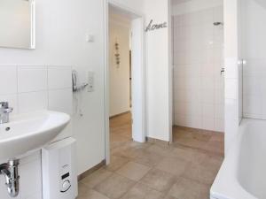 a white bathroom with a sink and a shower at Ferienhaus, Boiensdorf in Boiensdorf +12 photos