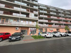 a parking lot with cars parked in front of a building at Apartmán Šantovka in Olomouc