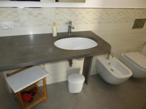 a bathroom with a sink and a toilet at Le Case Di Tufo- Casa del sole in Favignana