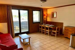 a living room with a table and chairs and a kitchen at Apartment Of 55 M With Balcony View Mont Blanc in Chamonix