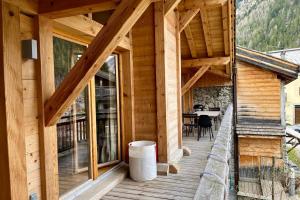 a wooden house with a balcony with a table at Chalet Of 235 M2 With Balcony Garden In Chamonix in Chamonix