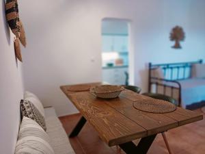a wooden table in a living room with a couch at Sugarstone House in Adamas