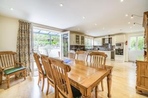 a kitchen and dining room with a wooden table and chairs at Hillberry in Grange Over Sands