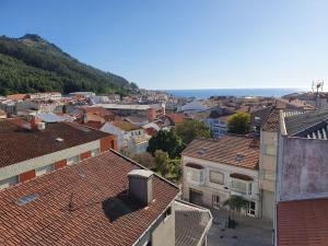 a view of a city with buildings and a mountain at Brisa Marina in A Guarda