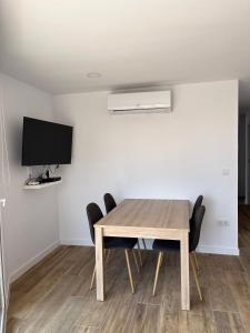 a dining room with a wooden table and chairs at Requena12 in Villajoyosa