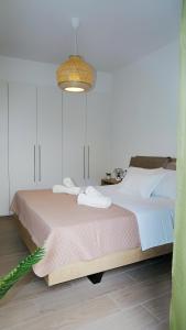 a bedroom with a large bed with a pink blanket at Urbanity - The Cretan Urban Experience in Heraklio