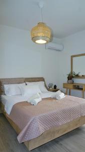 a bedroom with a bed with two towels on it at Urbanity - The Cretan Urban Experience in Heraklio