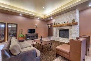 a living room with a couch and a fireplace at Best Western Dos Rios in Junction