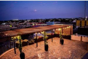 a view of a building with potted plants and lights at Cienaguas Hotel in Ciénaga