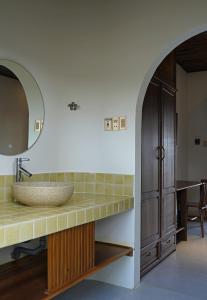 a bathroom with a sink and a mirror at Nhà mình homestay in Mỹ Lại (1)