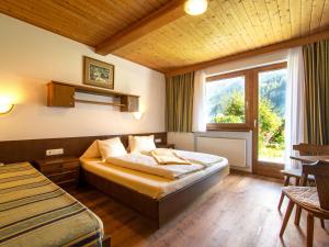 Postel nebo postele na pokoji v ubytování Ferienhaus Oblasser I
