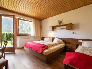 a bedroom with two beds and a window at Ferienhaus Oblasser II in Finkenberg