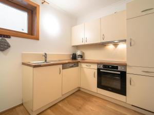 a kitchen with white cabinets and a sink at Ferienhaus Oblasser II in Finkenberg