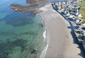 an aerial view of a beach and the ocean at Moody's Motel and Cottages in Wells