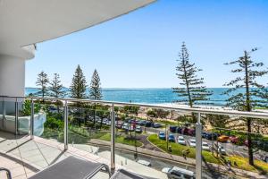 a balcony with a view of a parking lot and the ocean at Sirocco 507 by G1 Holidays in Mooloolaba