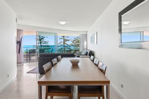 a dining room with a table and chairs at Sirocco 507 by G1 Holidays in Mooloolaba